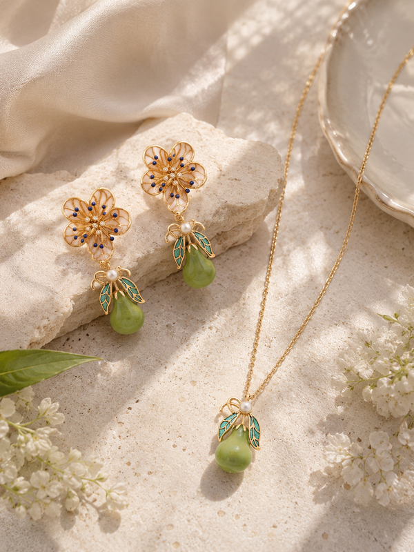 Gold necklace and earrings with green pear and floral accents 
