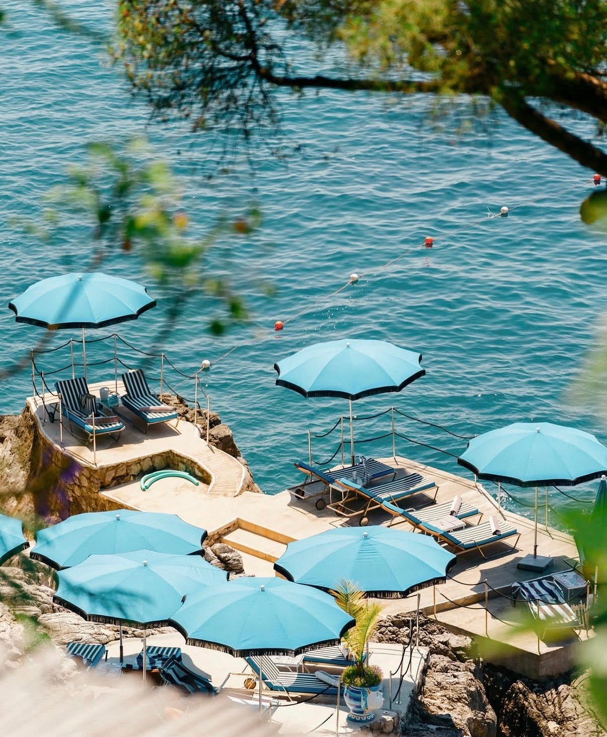 Blue beach umbrellas overlooking the Positano coastline