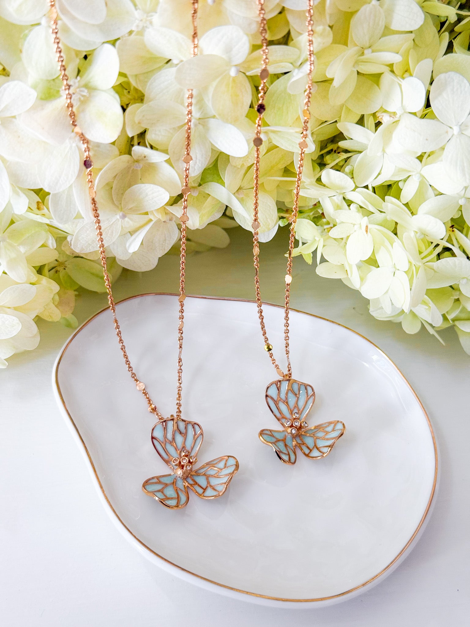 22k gold dipped necklace with a blue flower pendant_ closeup